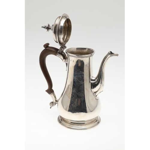 74 - A LATE GEORGE II SILVER COFFEE POT. Of plain baluster form, with scroll handle and round foot, the l... 
