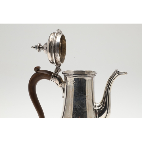 74 - A LATE GEORGE II SILVER COFFEE POT. Of plain baluster form, with scroll handle and round foot, the l... 
