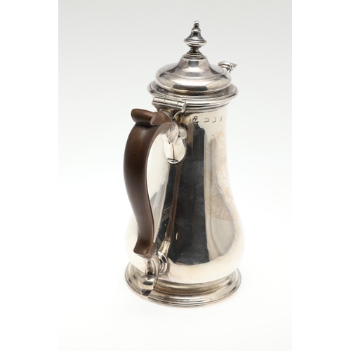 74 - A LATE GEORGE II SILVER COFFEE POT. Of plain baluster form, with scroll handle and round foot, the l... 
