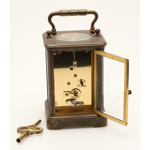 397 - A 19TH CENTURY FRENCH BRASS AND PORCELAIN CARRIAGE CLOCK. the case engraved with foliate detail and ... 