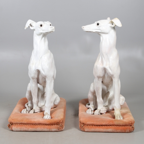 427 - A PAIR OF ITALIAN LIFE-SIZE CRACKLE GLAZE POTTERY GREYHOUNDS AND CUSHION BASES. in seated pose with ... 