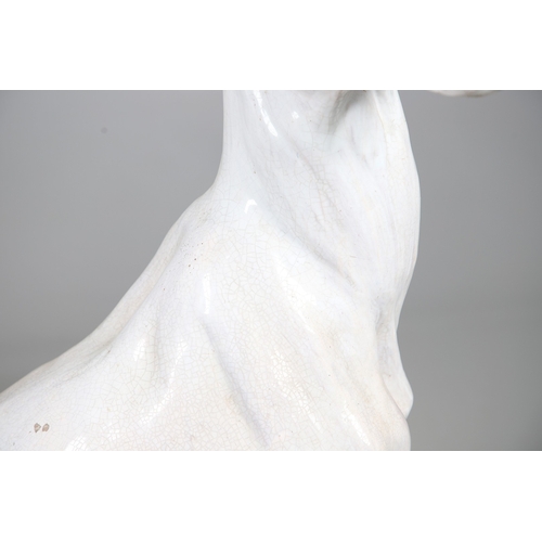 427 - A PAIR OF ITALIAN LIFE-SIZE CRACKLE GLAZE POTTERY GREYHOUNDS AND CUSHION BASES. in seated pose with ... 