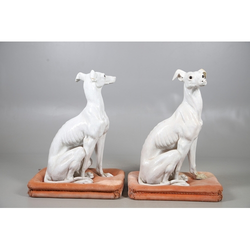 427 - A PAIR OF ITALIAN LIFE-SIZE CRACKLE GLAZE POTTERY GREYHOUNDS AND CUSHION BASES. in seated pose with ... 