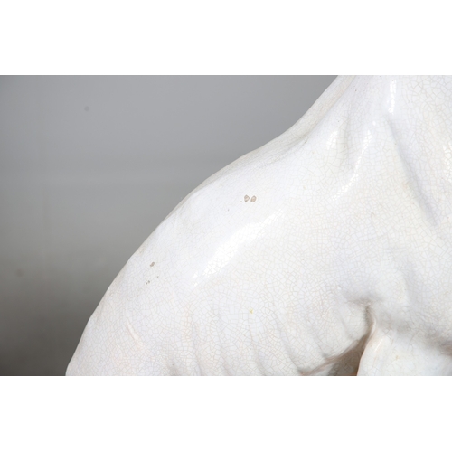 427 - A PAIR OF ITALIAN LIFE-SIZE CRACKLE GLAZE POTTERY GREYHOUNDS AND CUSHION BASES. in seated pose with ... 