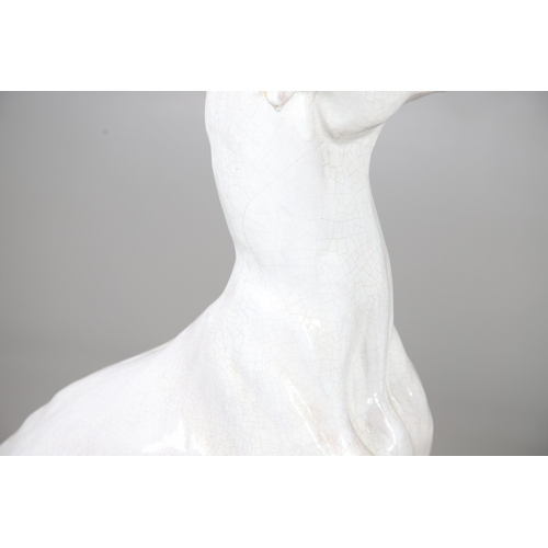 427 - A PAIR OF ITALIAN LIFE-SIZE CRACKLE GLAZE POTTERY GREYHOUNDS AND CUSHION BASES. in seated pose with ... 