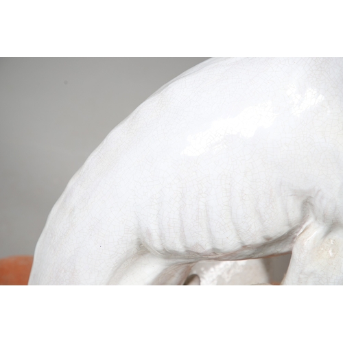 427 - A PAIR OF ITALIAN LIFE-SIZE CRACKLE GLAZE POTTERY GREYHOUNDS AND CUSHION BASES. in seated pose with ... 