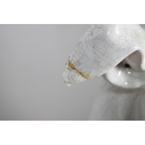 427 - A PAIR OF ITALIAN LIFE-SIZE CRACKLE GLAZE POTTERY GREYHOUNDS AND CUSHION BASES. in seated pose with ... 