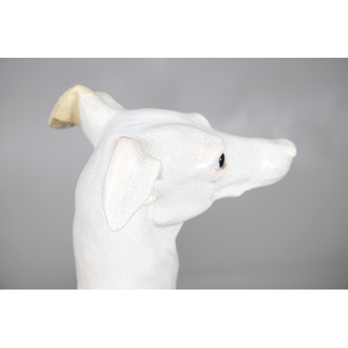 427 - A PAIR OF ITALIAN LIFE-SIZE CRACKLE GLAZE POTTERY GREYHOUNDS AND CUSHION BASES. in seated pose with ... 