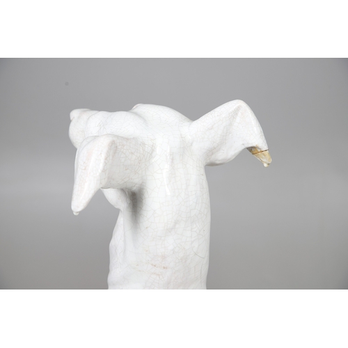 427 - A PAIR OF ITALIAN LIFE-SIZE CRACKLE GLAZE POTTERY GREYHOUNDS AND CUSHION BASES. in seated pose with ... 