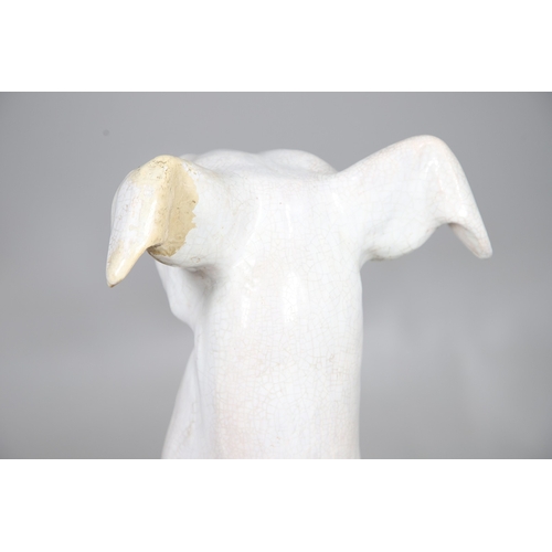 427 - A PAIR OF ITALIAN LIFE-SIZE CRACKLE GLAZE POTTERY GREYHOUNDS AND CUSHION BASES. in seated pose with ... 