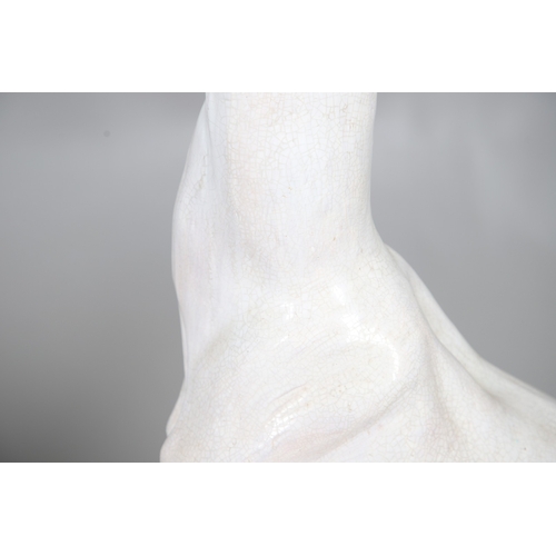 427 - A PAIR OF ITALIAN LIFE-SIZE CRACKLE GLAZE POTTERY GREYHOUNDS AND CUSHION BASES. in seated pose with ... 