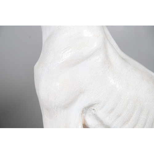 427 - A PAIR OF ITALIAN LIFE-SIZE CRACKLE GLAZE POTTERY GREYHOUNDS AND CUSHION BASES. in seated pose with ... 