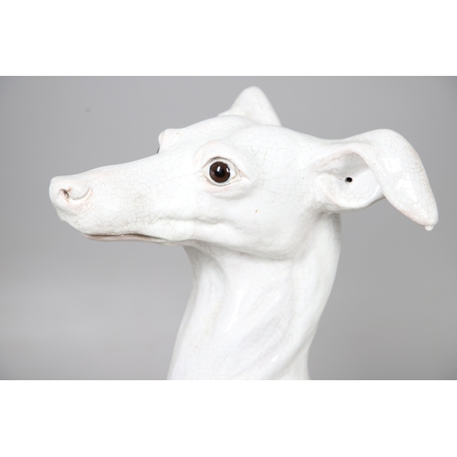427 - A PAIR OF ITALIAN LIFE-SIZE CRACKLE GLAZE POTTERY GREYHOUNDS AND CUSHION BASES. in seated pose with ... 