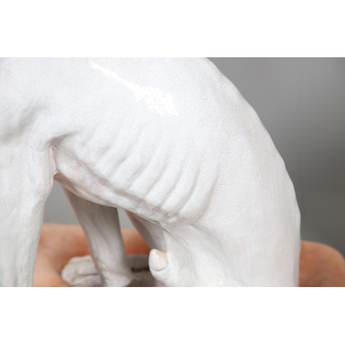 427 - A PAIR OF ITALIAN LIFE-SIZE CRACKLE GLAZE POTTERY GREYHOUNDS AND CUSHION BASES. in seated pose with ... 