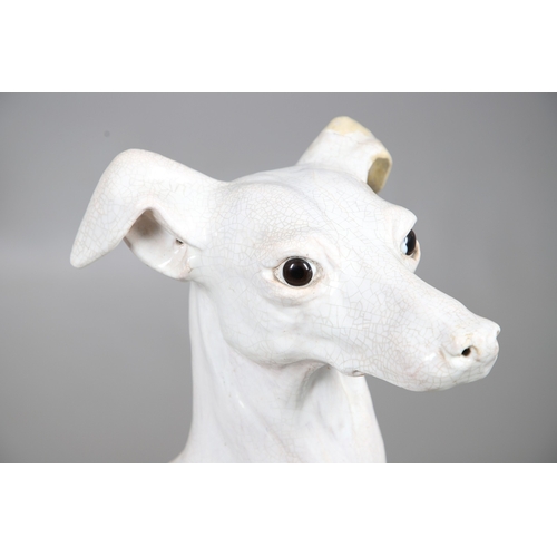 427 - A PAIR OF ITALIAN LIFE-SIZE CRACKLE GLAZE POTTERY GREYHOUNDS AND CUSHION BASES. in seated pose with ... 