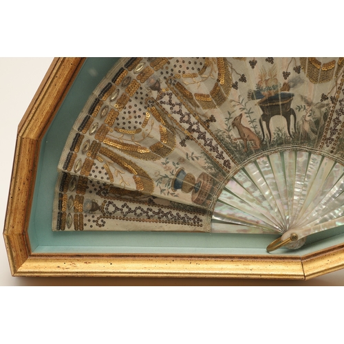429 - A REGENCY MOTHER OF PEARL AND SEQUINNED FAN. painted with Classical decoration of urns, doves, a hou... 