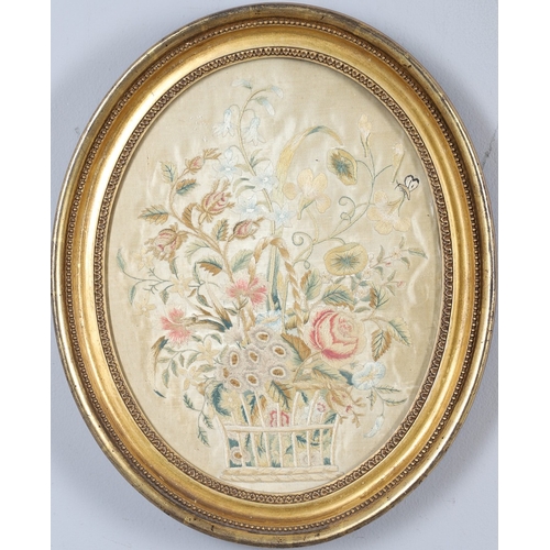 434 - A REGENCY OVAL SILKWORK FLORAL PICTURE. depicting a basket of flowers within a gilded frame, 39cm x ... 