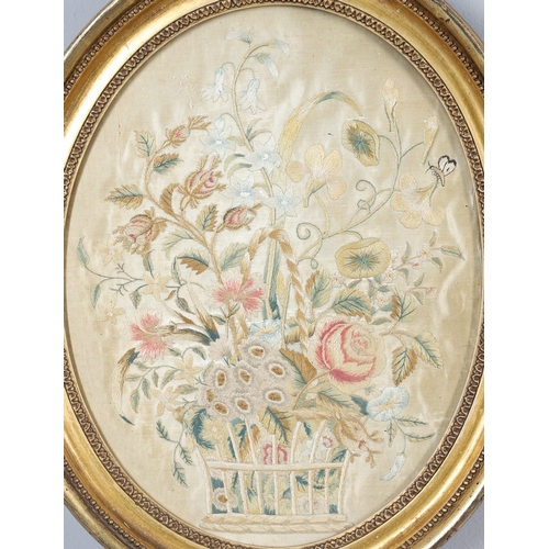 434 - A REGENCY OVAL SILKWORK FLORAL PICTURE. depicting a basket of flowers within a gilded frame, 39cm x ... 