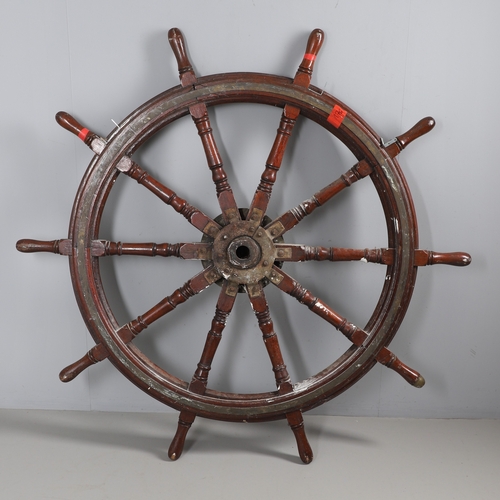 444 - A LARGE MAHOGANY AND BRASS BOUND SHIP'S WHEEL. unattributed, set with two half pennys, dated 1952, 1... 