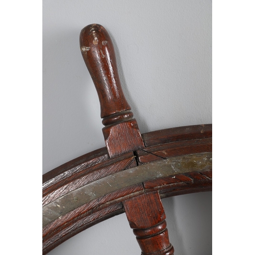 444 - A LARGE MAHOGANY AND BRASS BOUND SHIP'S WHEEL. unattributed, set with two half pennys, dated 1952, 1... 