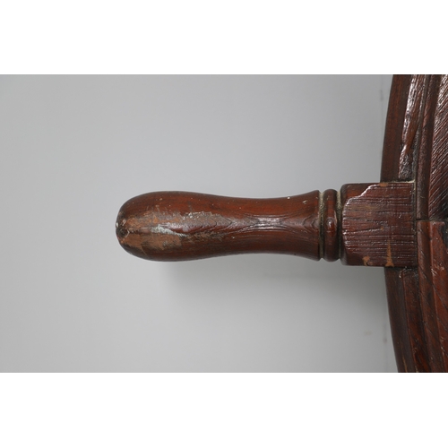 444 - A LARGE MAHOGANY AND BRASS BOUND SHIP'S WHEEL. unattributed, set with two half pennys, dated 1952, 1... 