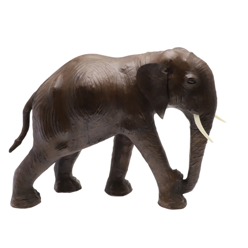 446 - A LARGE LEATHER COVERED ELEPHANT, IN THE STYLE OF OMERSA FOR LIBERTY. with moveable soft leather ear... 