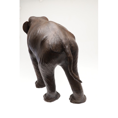 446 - A LARGE LEATHER COVERED ELEPHANT, IN THE STYLE OF OMERSA FOR LIBERTY. with moveable soft leather ear... 