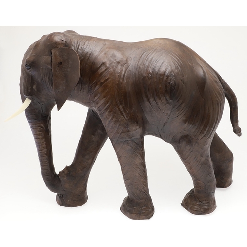 446 - A LARGE LEATHER COVERED ELEPHANT, IN THE STYLE OF OMERSA FOR LIBERTY. with moveable soft leather ear... 