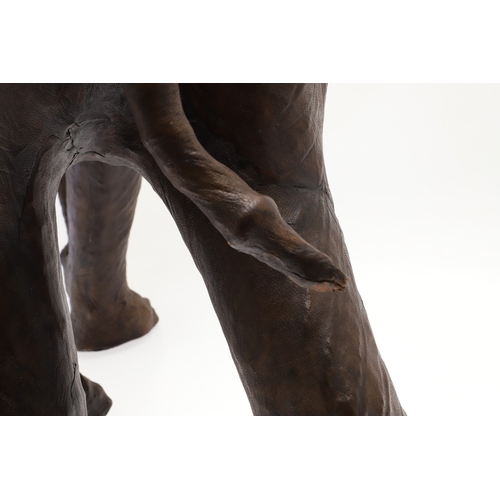 446 - A LARGE LEATHER COVERED ELEPHANT, IN THE STYLE OF OMERSA FOR LIBERTY. with moveable soft leather ear... 