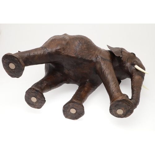 446 - A LARGE LEATHER COVERED ELEPHANT, IN THE STYLE OF OMERSA FOR LIBERTY. with moveable soft leather ear... 
