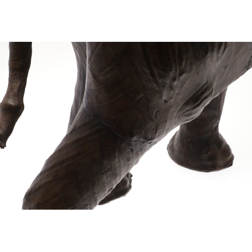 446 - A LARGE LEATHER COVERED ELEPHANT, IN THE STYLE OF OMERSA FOR LIBERTY. with moveable soft leather ear... 