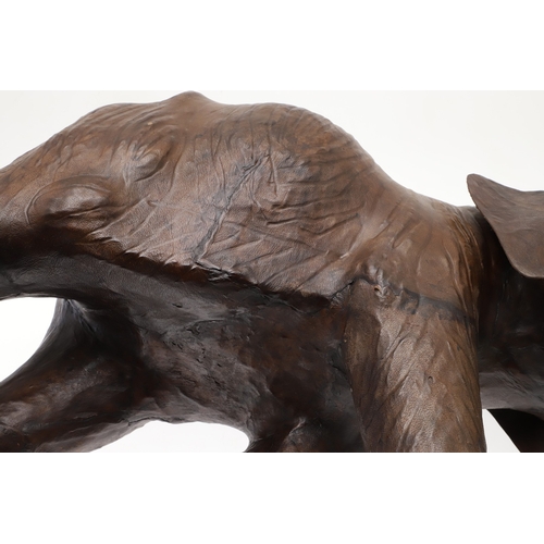 446 - A LARGE LEATHER COVERED ELEPHANT, IN THE STYLE OF OMERSA FOR LIBERTY. with moveable soft leather ear... 