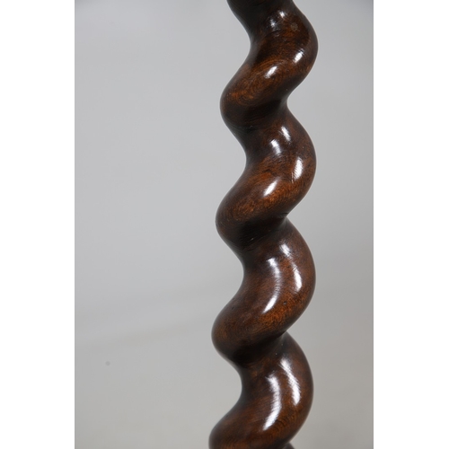 468 - AN 18TH CENTURY WALNUT CANDLESTAND (MARRIAGE). the octagonal oyster veneered to a spiral column and ... 