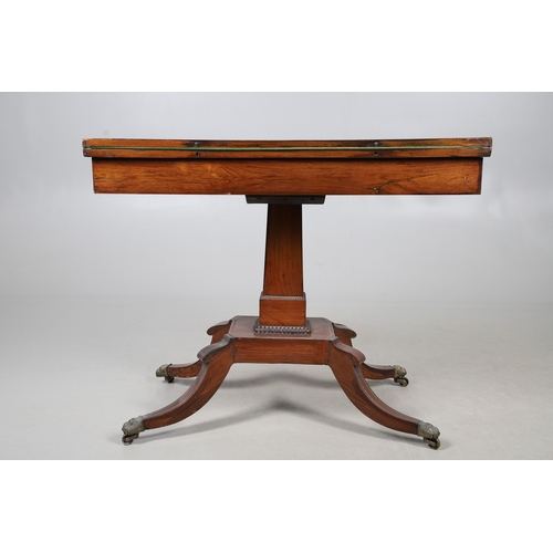 475 - A PAIR OF REGENCY ROSEWOOD AND BRASS INLAID GAMES TABLES. with D-end baize lined swivel tops, inlaid... 