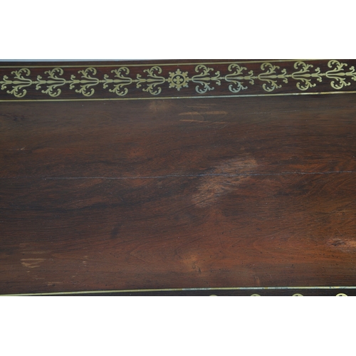 475 - A PAIR OF REGENCY ROSEWOOD AND BRASS INLAID GAMES TABLES. with D-end baize lined swivel tops, inlaid... 