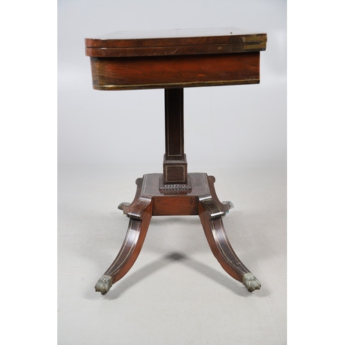 475 - A PAIR OF REGENCY ROSEWOOD AND BRASS INLAID GAMES TABLES. with D-end baize lined swivel tops, inlaid... 