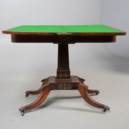 475 - A PAIR OF REGENCY ROSEWOOD AND BRASS INLAID GAMES TABLES. with D-end baize lined swivel tops, inlaid... 