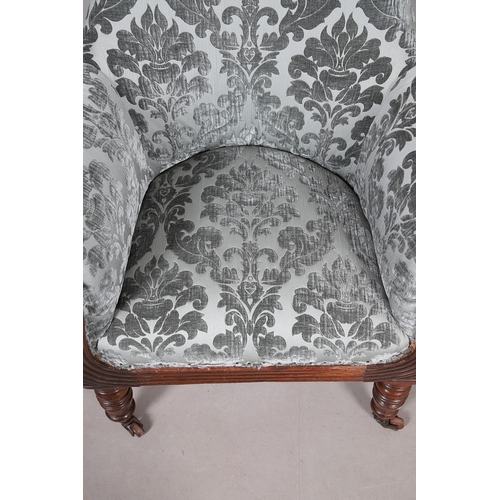 476 - A WILLIAM IV GILLOWS STYLE MAHOGANY LIBRARY CHAIR. the concave back to overstuffed arms, carved reed... 