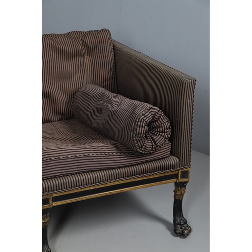 493 - A REGENCY EBONISED AND GILT FRAME THREE SEAT SETTEE IN THE MANNER OF GEORGE BULLOCK. upon eight ebon... 