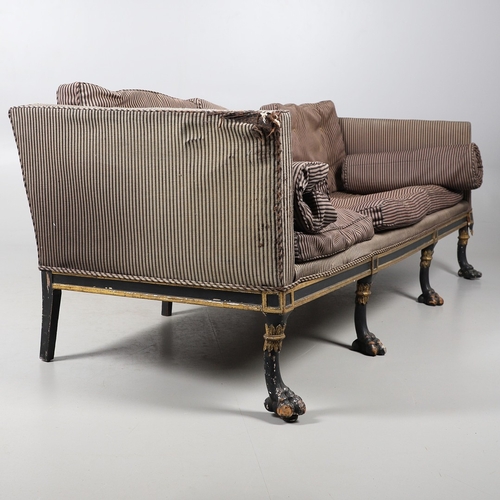 493 - A REGENCY EBONISED AND GILT FRAME THREE SEAT SETTEE IN THE MANNER OF GEORGE BULLOCK. upon eight ebon... 