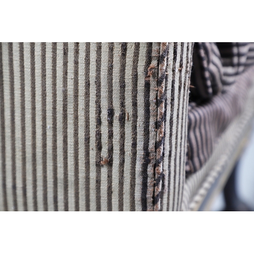 493 - A REGENCY EBONISED AND GILT FRAME THREE SEAT SETTEE IN THE MANNER OF GEORGE BULLOCK. upon eight ebon... 