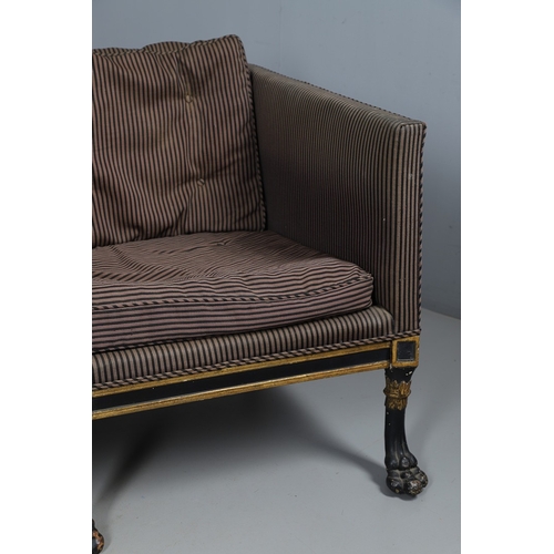 493 - A REGENCY EBONISED AND GILT FRAME THREE SEAT SETTEE IN THE MANNER OF GEORGE BULLOCK. upon eight ebon... 