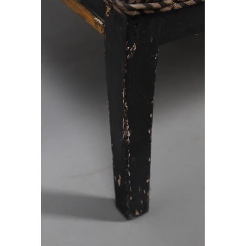 493 - A REGENCY EBONISED AND GILT FRAME THREE SEAT SETTEE IN THE MANNER OF GEORGE BULLOCK. upon eight ebon... 