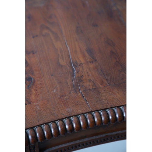 502 - A REGENCY YEW WOOD SIDE TABLE. the shaped top with canted corners and half beaded border, above acan... 