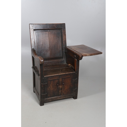 514 - AN UNUSUAL 17TH CENTURY OAK CHAIR. with panelled back and sides, hinged side flap with supporting ir... 