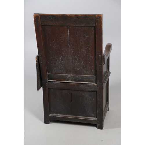 514 - AN UNUSUAL 17TH CENTURY OAK CHAIR. with panelled back and sides, hinged side flap with supporting ir... 