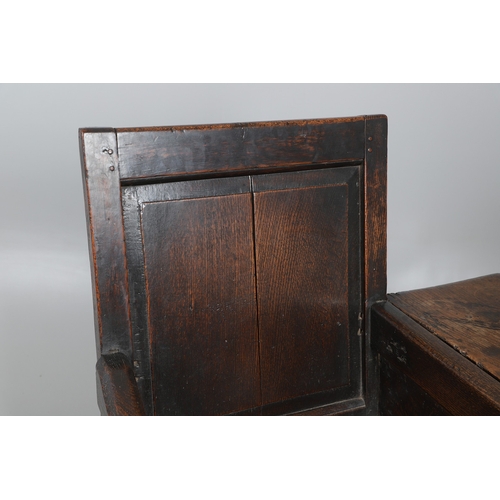 514 - AN UNUSUAL 17TH CENTURY OAK CHAIR. with panelled back and sides, hinged side flap with supporting ir... 