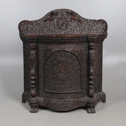 521 - A 19TH CENTURY BURMESE HARDWOOD SIDE CABINET. the raised back over a serpentine front and concave si... 