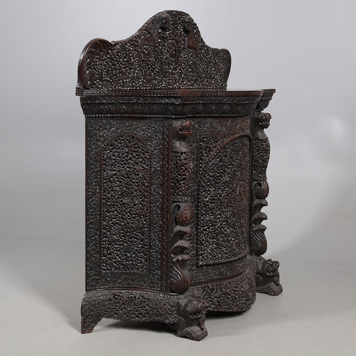 521 - A 19TH CENTURY BURMESE HARDWOOD SIDE CABINET. the raised back over a serpentine front and concave si... 