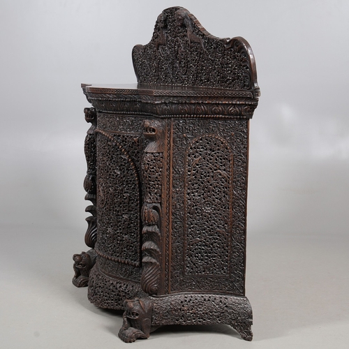 521 - A 19TH CENTURY BURMESE HARDWOOD SIDE CABINET. the raised back over a serpentine front and concave si... 